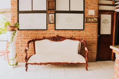 a bench in a room with a brick wall at Hotel Ibatama in Cartagena de Indias