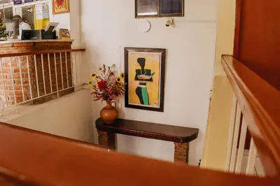 a stairway with a vase of flowers on a table at Hotel Ibatama in Cartagena de Indias