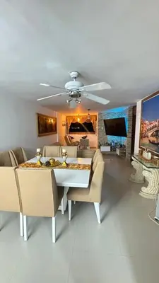 a living room with a table and chairs and a couch at Acogedor espacio familiar in Cartagena de Indias