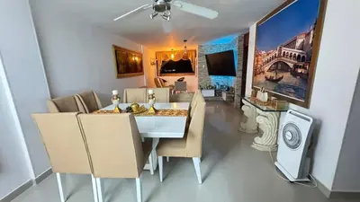 a dining room with a white table and chairs at Acogedor espacio familiar in Cartagena de Indias