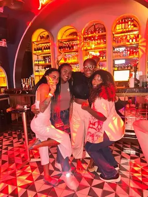 a group of people posing for a picture in a bar at Cartagena Rumbera in Cartagena de Indias