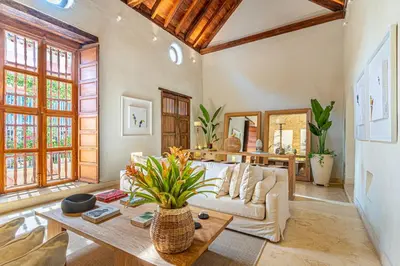 a living room with a couch and a table at Casa Emilia - Luxury Villa in the Historic Center in Cartagena de Indias
