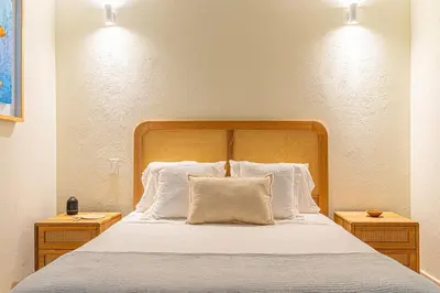 a bedroom with a large bed with white pillows at Casa Emilia - Luxury Villa in the Historic Center in Cartagena de Indias