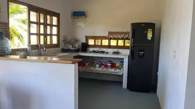 a kitchen with a black refrigerator and a counter at Mi refugio in Moñitos