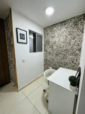 a room with a white desk and a wall at cool and quiet apartment in front of the urban forest in Barranquilla