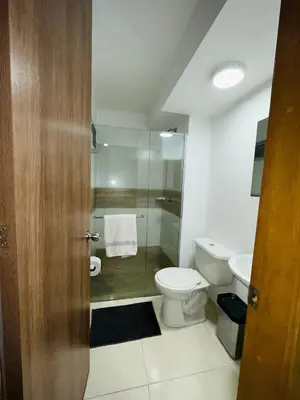 a bathroom with a toilet and a sink at cool and quiet apartment in front of the urban forest in Barranquilla