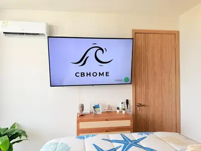 a television hanging on a wall above a bed at Magnificent Apartment - Beach - Jacuzzis! in Cartagena de Indias