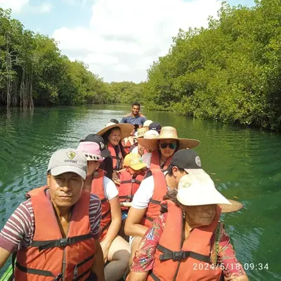 a group of people in a boat on a river at Habitacion Ely Johana in Coveñas