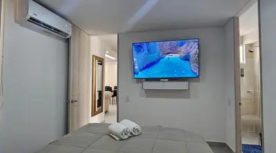 a bedroom with a flat screen tv on a wall at Modern apt in Cartagena with pool and beach access in Cartagena de Indias