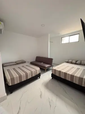 a bedroom with two beds and a couch in it at Maru apartamentos #5 in Cartagena de Indias