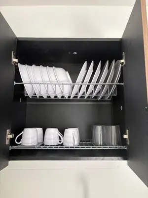 a kitchen shelf with white plates and pans at Maru apartamentos #5 in Cartagena de Indias