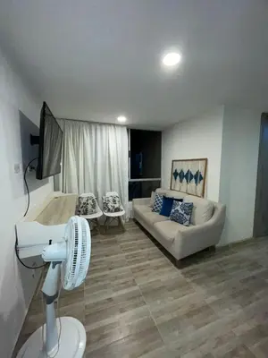 a living room with a couch and a fan at Exclusivo apartamento en ciudad Mallorquin in Barranquilla