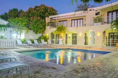a swimming pool in front of a house at Hotel Santorini Casablanca Resort in Santa Marta