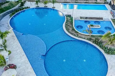 an overhead view of a large blue swimming pool at Loft cerca a la playa en Santa Marta Wi-Fi- Santa Marina in Santa Marta