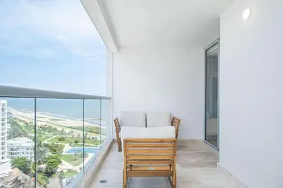 a room with a bed and a large window at Elegant Beachview 1BR with Balcony in Crespo in Cartagena de Indias