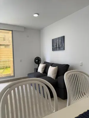a living room with a black couch and a window at A pasos de playa privada Serena del Mar Cartagena in Cartagena de Indias