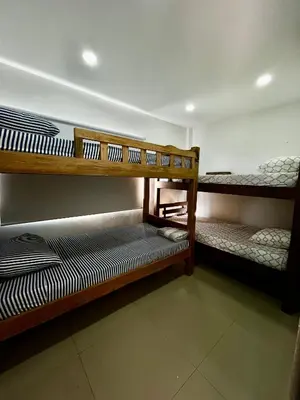 a room with three bunk beds in it at Apartamento DUPLEX para Grupos 9 pax in Cartagena de Indias