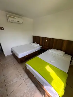 a bedroom with two beds and a radiator at Hotel Palma Grande By Origen