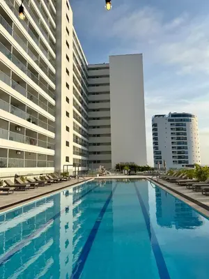 a large swimming pool in front of a building at Lovely Suite steps away from the airport and beach in Cartagena de Indias