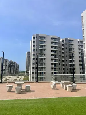 a group of benches in front of tall buildings at Apto de lujo en Barranquilla in Barranquilla