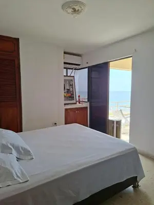 a bedroom with a bed with a view of the ocean at Relajación y vista al mar en hermoso apartamento en Cartagena in Cartagena de Indias