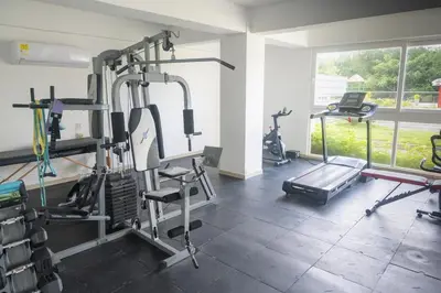 a gym with several tread machines in a room at Ocean View Apartment - Soho Playa Mendoza in Tubará