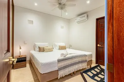 a white bedroom with a bed and a ceiling fan at Luxury House in the heart of Cartagena with Jacuzzi in Cartagena de Indias