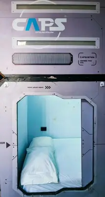 a small bed in a room with a mirror at Hotel Capsula CAPS Cartagena in Cartagena de Indias