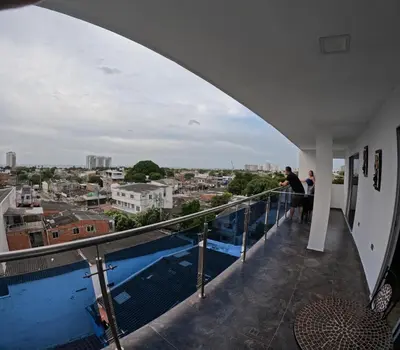 a man standing on a balcony looking out over a city at Viewpoint apartment near the Historic Center in Cartagena de Indias