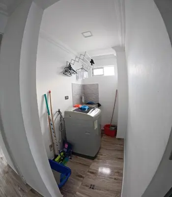 an attic room with a washing machine in a room at Viewpoint apartment near the Historic Center in Cartagena de Indias