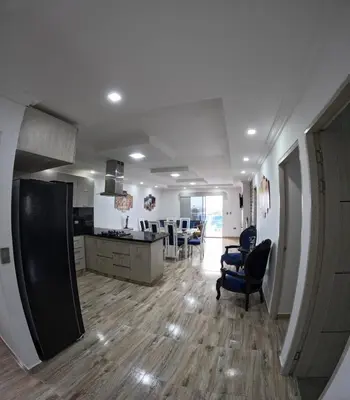 a kitchen and living room with chairs and a table at Viewpoint apartment near the Historic Center in Cartagena de Indias