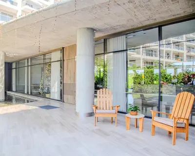 two chairs and a table in front of a building at Apt 2 rooms with private beach and ideal pool in Cartagena de Indias