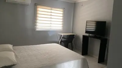 a bedroom with a bed and a desk and a television at Hotel Tres Estrellas Fundacion in Fundación