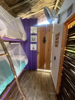 a room with a bunk bed and a hallway at Riders Shared Room en Mojarra Beach in Salina de Rey