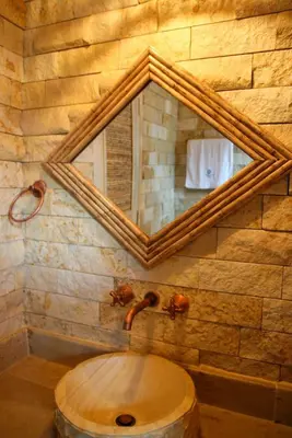 a bathroom with a mirror and a wooden sink at Mero Beach - Apartamento frente al mar en Tolú in San Silvestre
