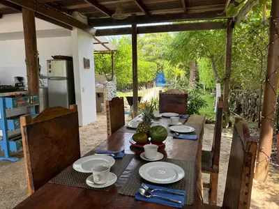 a wooden table with plates of food on it at Suemar Cabaña de Playa en Isla de Tierra Bomba in Cartagena de Indias