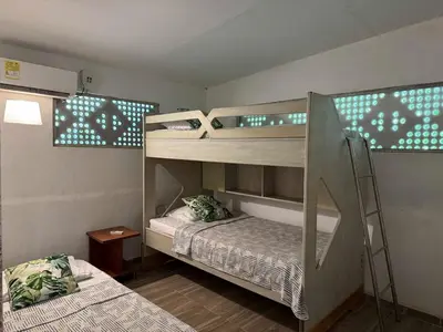 two bunk beds in a room with a ladder at Suemar Cabaña de Playa en Isla de Tierra Bomba in Cartagena de Indias