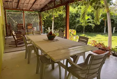 a wooden table and chairs on a patio at Suemar Cabaña de Playa en Isla de Tierra Bomba in Cartagena de Indias