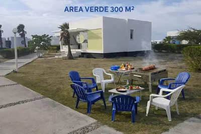a group of chairs and a table and a grill at Marina Puerto Velero Cabaña in Tubará