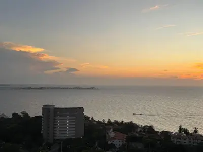 a view of the ocean at sunset from a building at Oceanfront Loft with Incredible View in Santa Marta