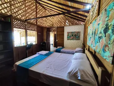 a bedroom with two beds in a room at Cabaña 8 personas frente al mar con deck privado in Moñitos