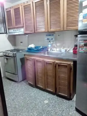 a kitchen with a sink and a stove at hermosa habitacion in Barranquilla