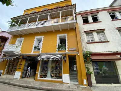 a yellow building with a balcony on top of it at Experience the magic of the Calle de las Damas historic center in Cartagena de Indias