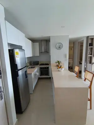 a kitchen with a refrigerator and a counter top at 612 Beautiful Apartment Near the Walled City in Cartagena de Indias