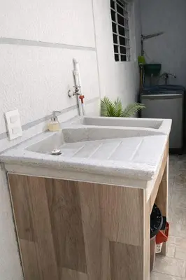 a bathroom sink with a concrete counter top at Apartamento cerca a la playa y al aeropuerto in Santa Marta