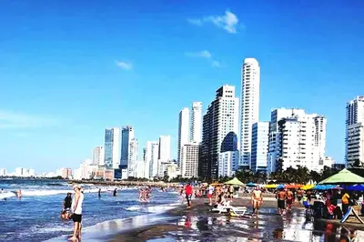 a group of people on a beach with buildings at Beatifull apartment near Hilton hotel in Cartagena de Indias