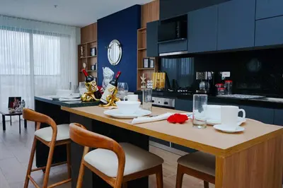 a kitchen with a wooden island with chairs and a table at NEW Apartment, best rooftop pool view, Cartagena - Visitors NOT ALLOWED in Cartagena de Indias