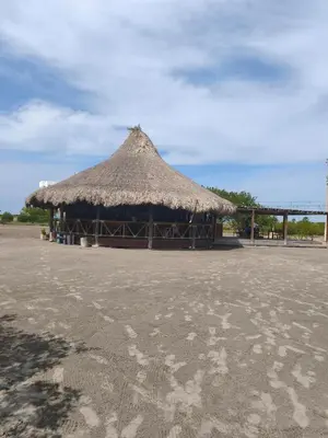 a hut with a straw roof on a beach at Apto puerto velero in Barranquilla