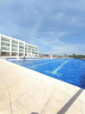a large swimming pool next to a large building at Apto puerto velero in Barranquilla