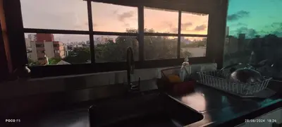 a kitchen with a sink and a window with a view at Hotel WK Casa de Hospedaje in Barranquilla